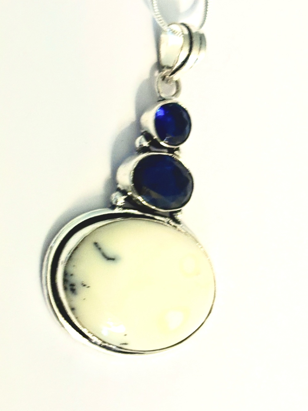925 marked, Dendrite Opal and Tanzanite gemstone pendant on a silver chain.